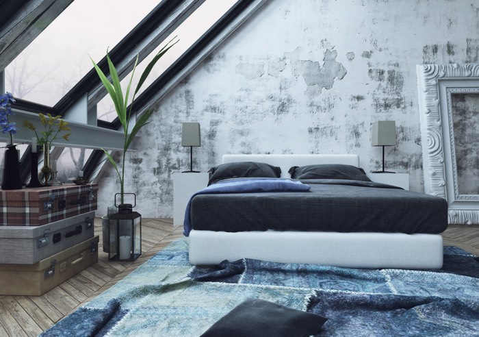 Chambre moderne grise chic avec grand lit bleu-gris et tapis dans un genre ethnique chic. Parquet et grand tableau blanc vide sur le côté.