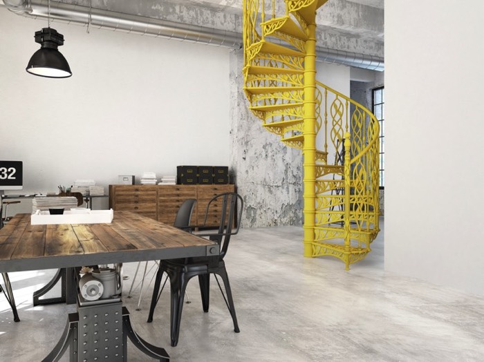 Salle à manger au style industriel avec escalier en colimaçon jaune clair sur sol blanc-gris. Table rectangulaire en bois, fauteuils gris, meuble avec tiroirs et lampe suspendue noire.