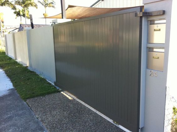 Portail aluminium contemporain plein couleur sobre gris-vert clair. Grand mur blanc et deux boites aux lettres intégrées dans le pilier.